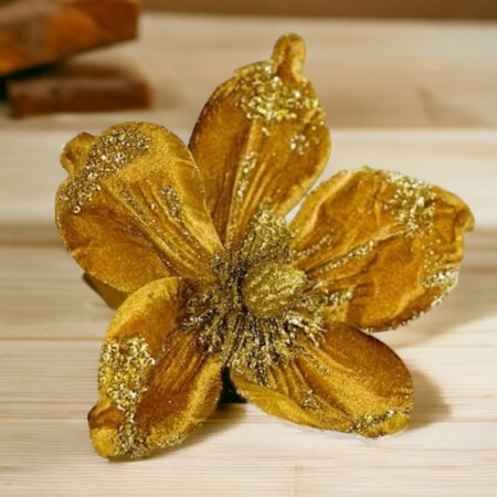 Guldfärgad dekorationsblomma med pinne
